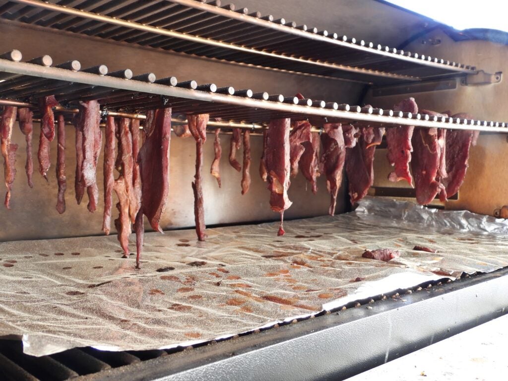 Strips of jerky in a smoker