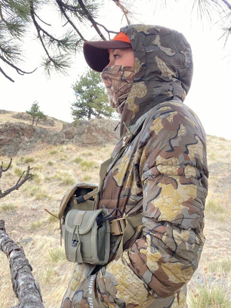 A woman wearing KUIU Women’s Super Down ULTRA Hooded Jacket