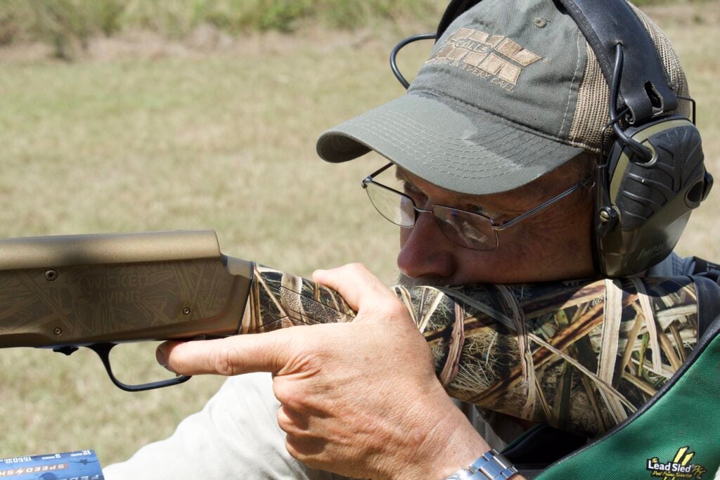 Man shooting a shotgun