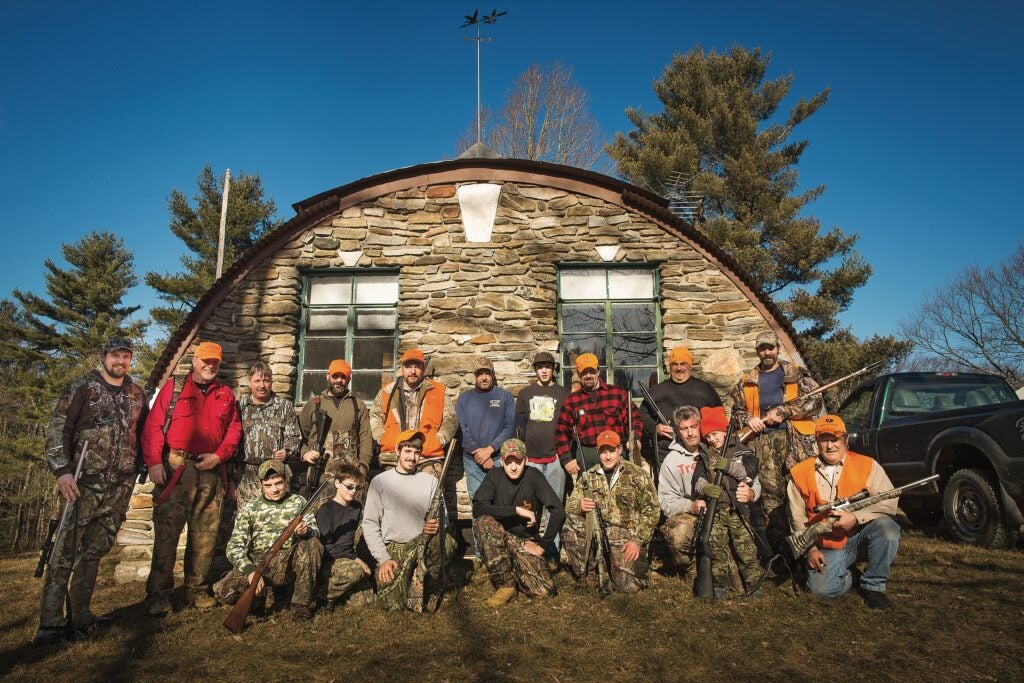 Hunters gathered around a quonset hut.