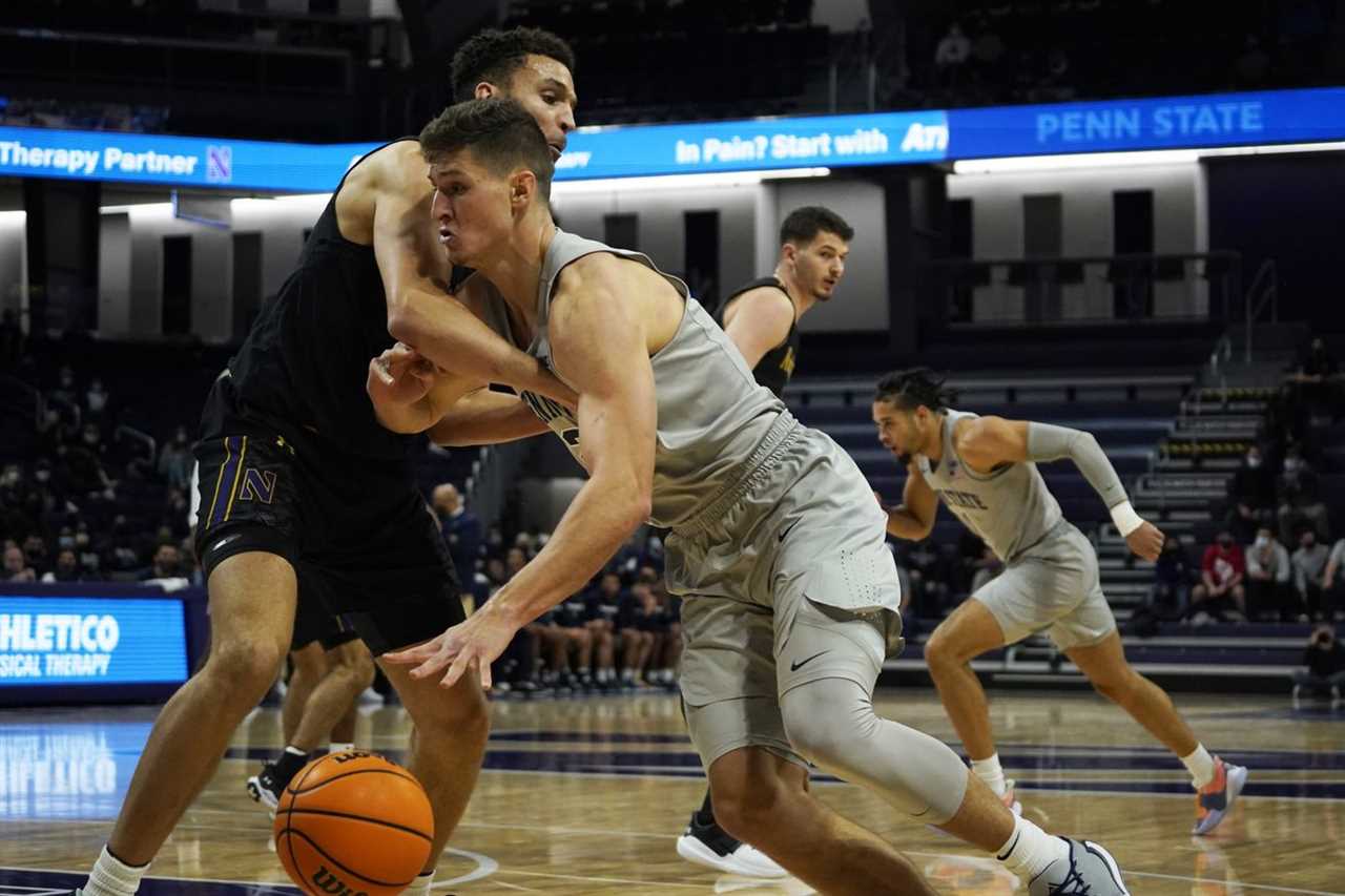 Penn State Nittany Lions forward John Harrar (21) is defended by Northwestern Wildcats forward Pete Nance (22) during the first half at Welsh-Ryan Arena.