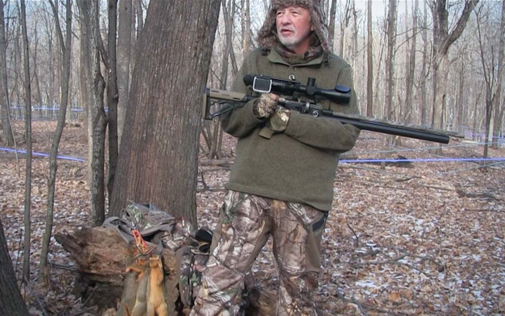 A man holding a black air rifle