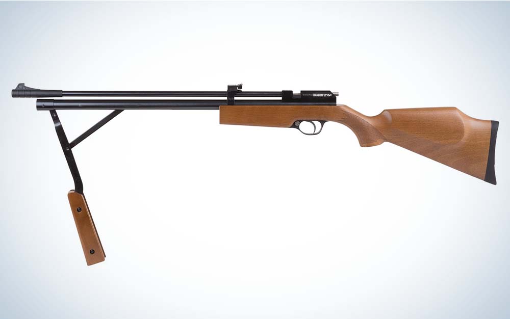 A brown wood air rifle with a black barrel