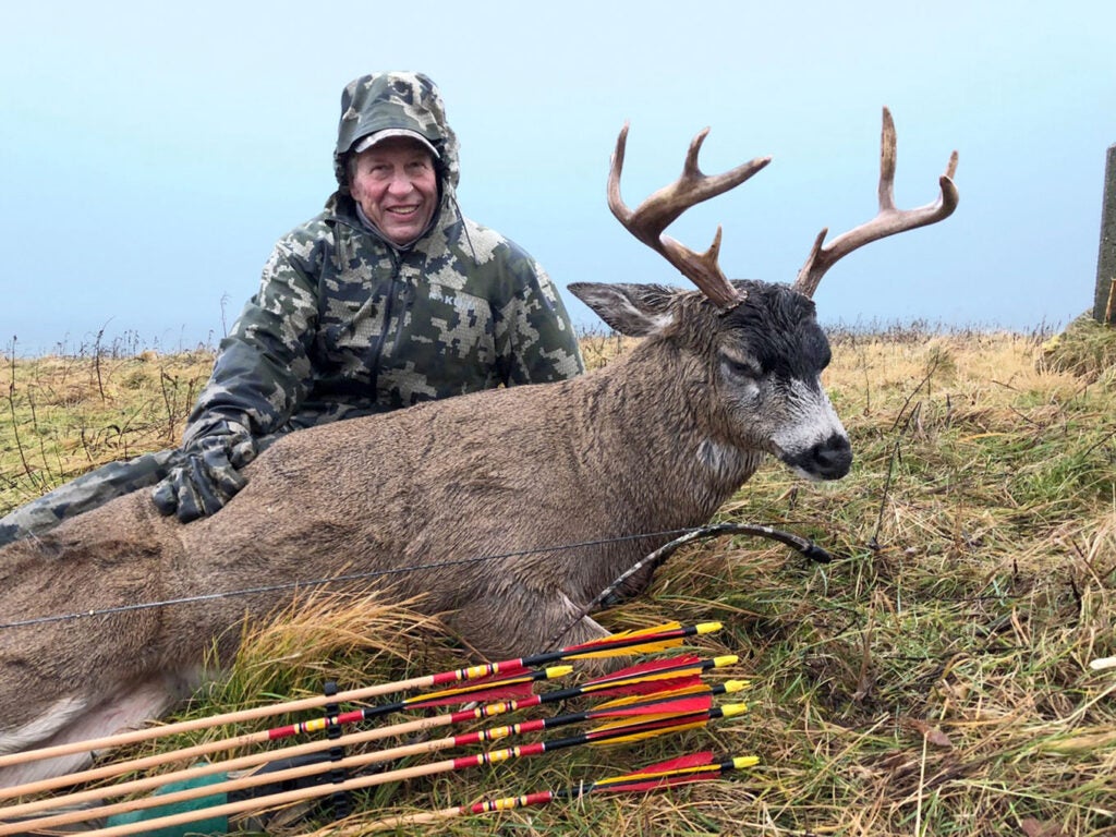 hunter with blacktail buck