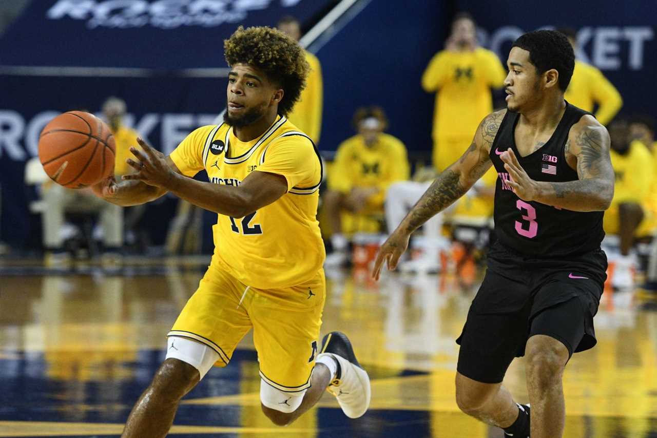 Michigan Wolverines guard Mike Smith (12) drives to the basket as Penn State Nittany Lions guard Sam Sessoms (3) defends during the first half at Crisler Center.