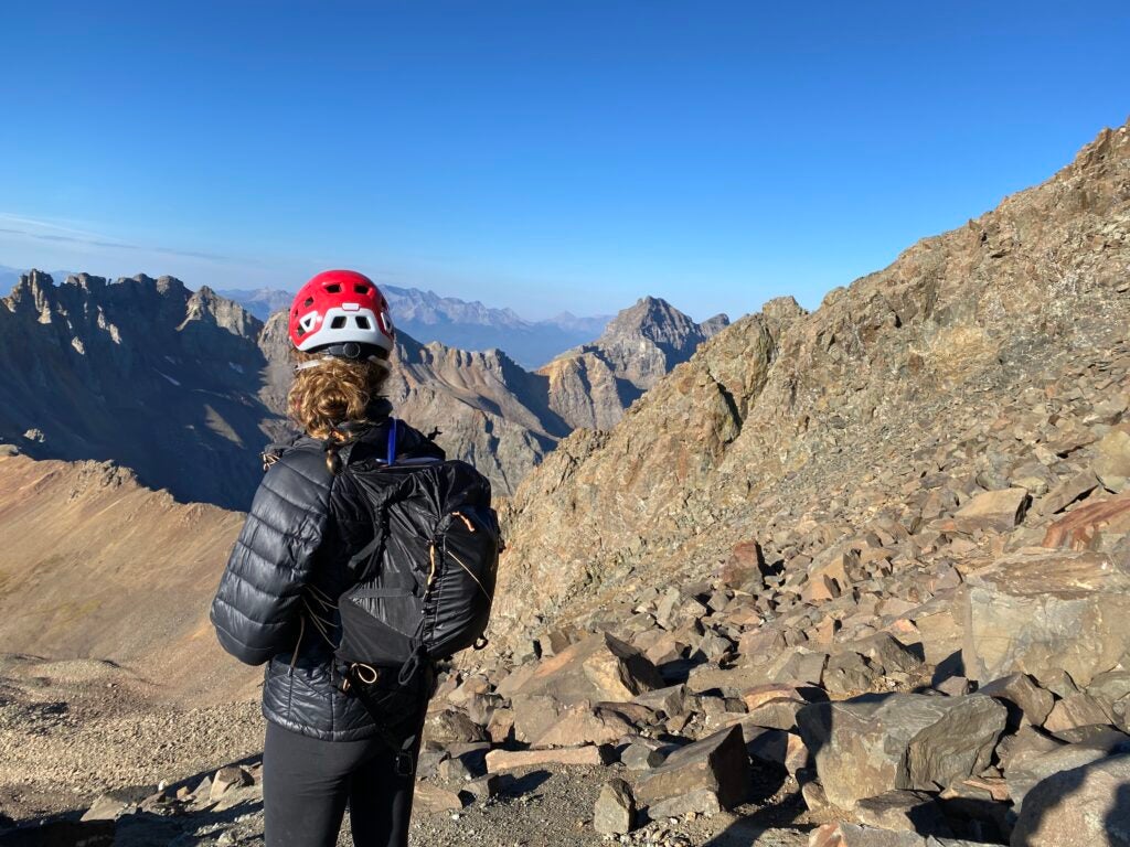 A woman wearing the best lightweight backpack and a red helmet