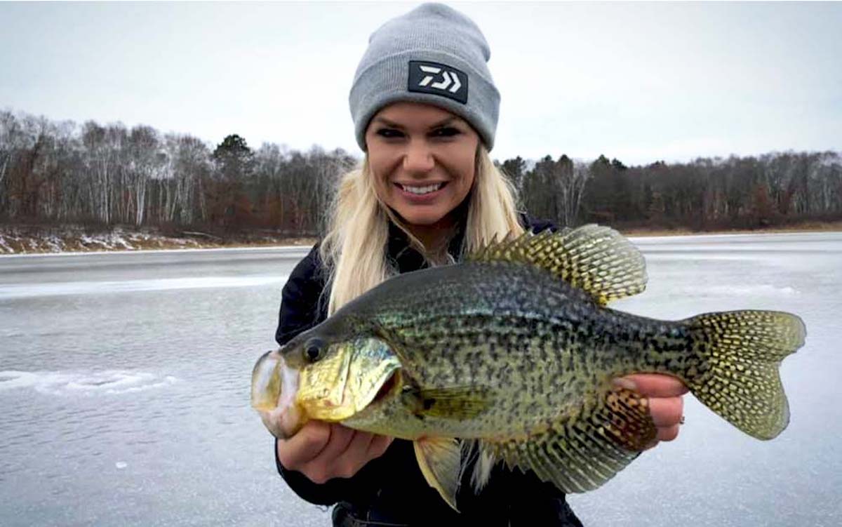 A woman holding a large fish