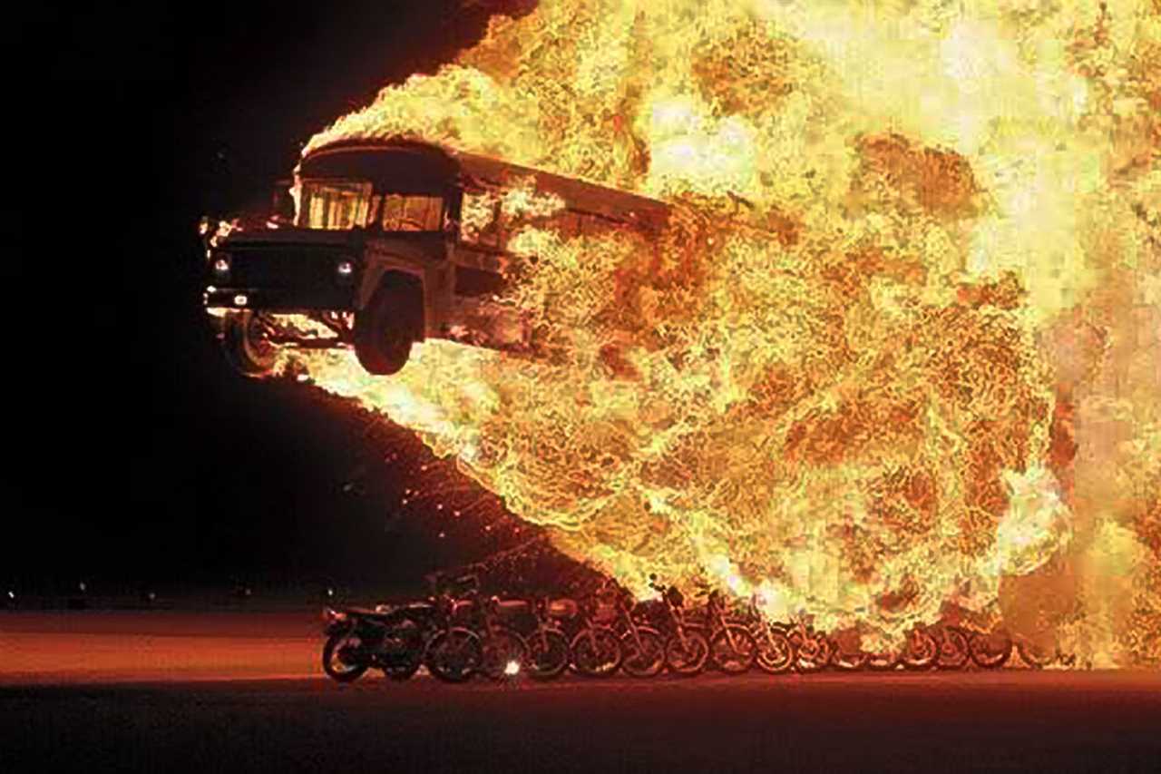 Flaming Bus Jumping over a line of motorcycles.