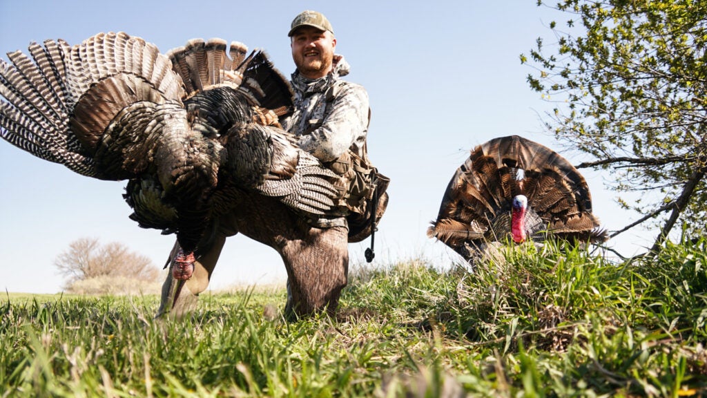 Hunter with a turkey and turkey decoy