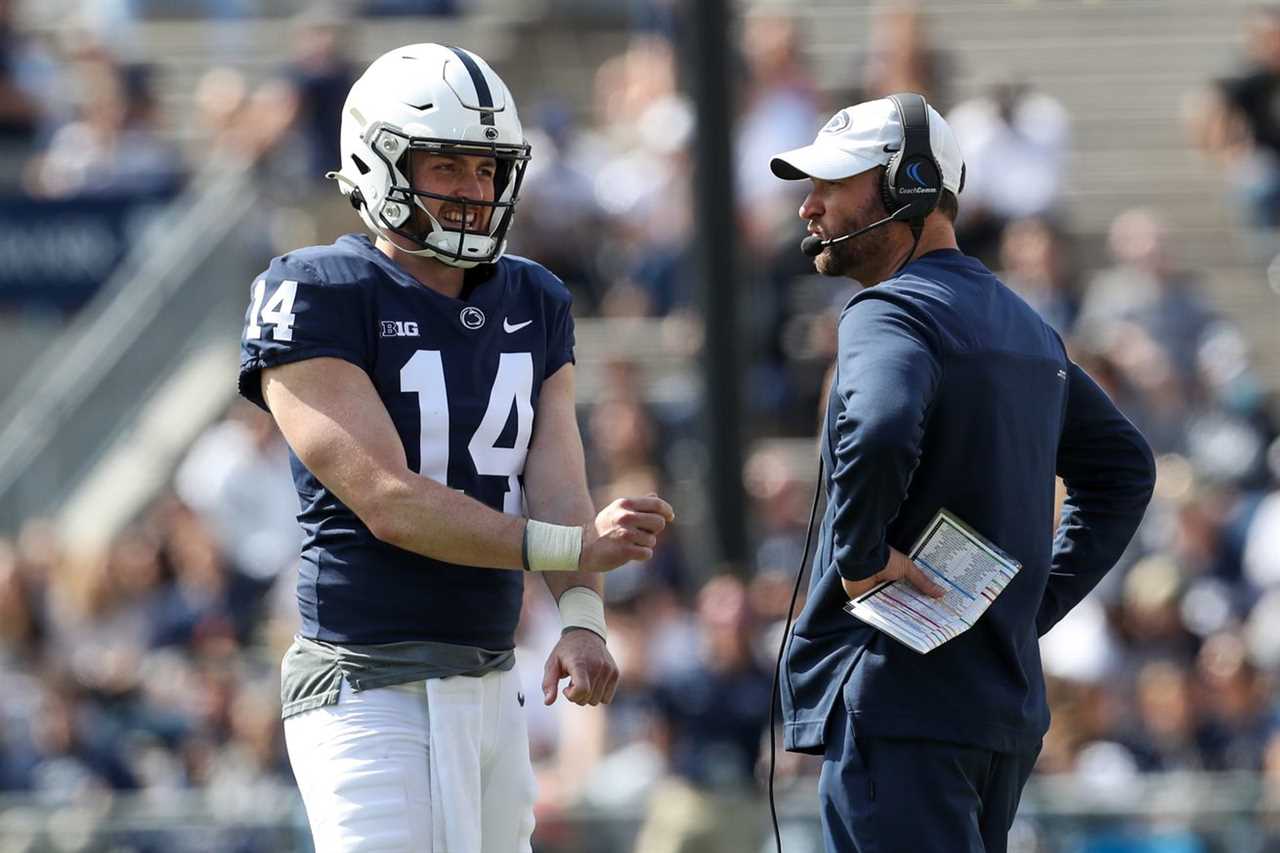 Penn State Nittany Lions offensive coordinator Mike Yurcich talks with quarterback Sean Clifford (14) during the Blue White spring game at Beaver Stadium.