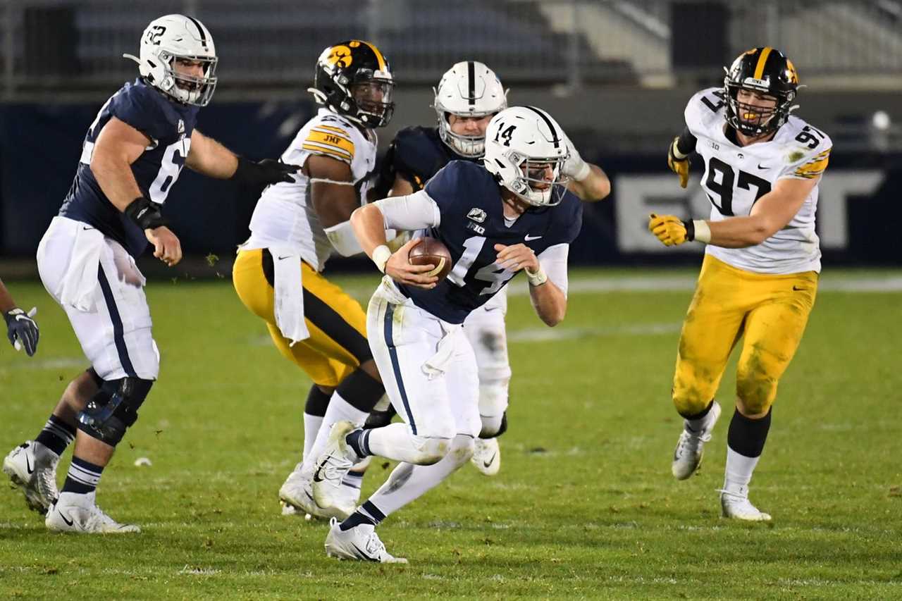 Sean Clifford avoid Iowa defenders while trying to make a play.