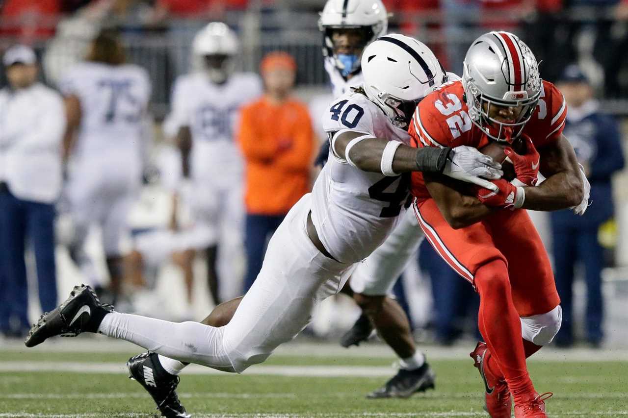 Ohio State Buckeyes running back TreVeyon Henderson (32) is tackled by Penn State Nittany Lions linebacker Jesse Luketa (40) during Saturday’s NCAA Division I football game at Ohio Stadium in Columbus on October 30, 2021.