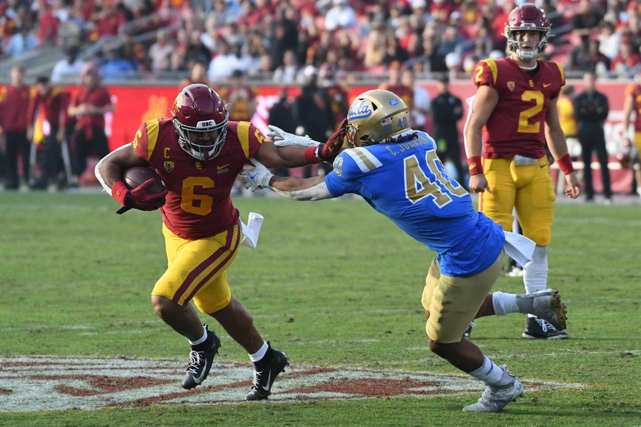 Southern California Trojans running back Vavae Malepeai (6) runs the ball against UCLA Bruins linebacker Caleb Johnson (40) in the second half at the Los Angeles Memorial Coliseum.