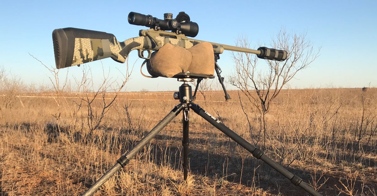 rifle on shooting bag with tripod