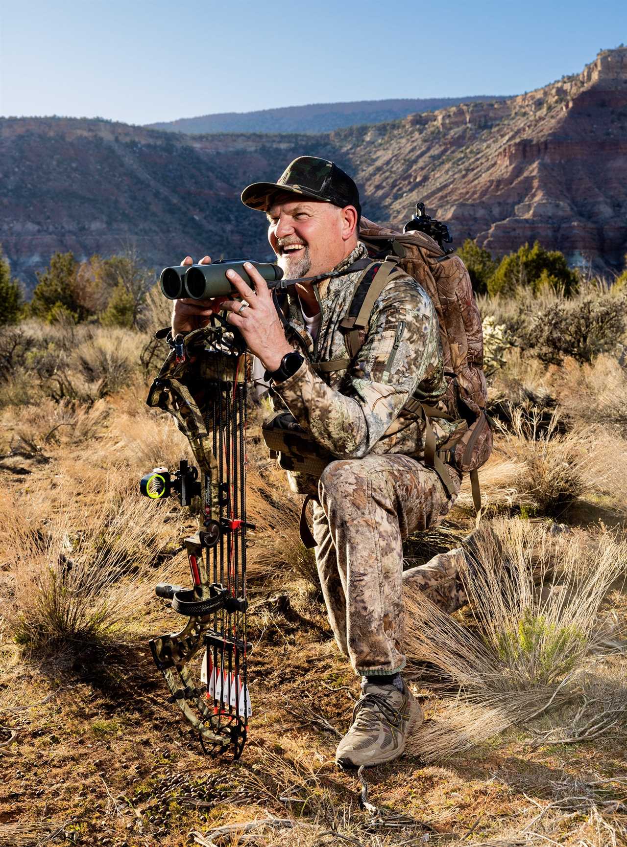 Michael Hirschi hold binoculars atop a bow