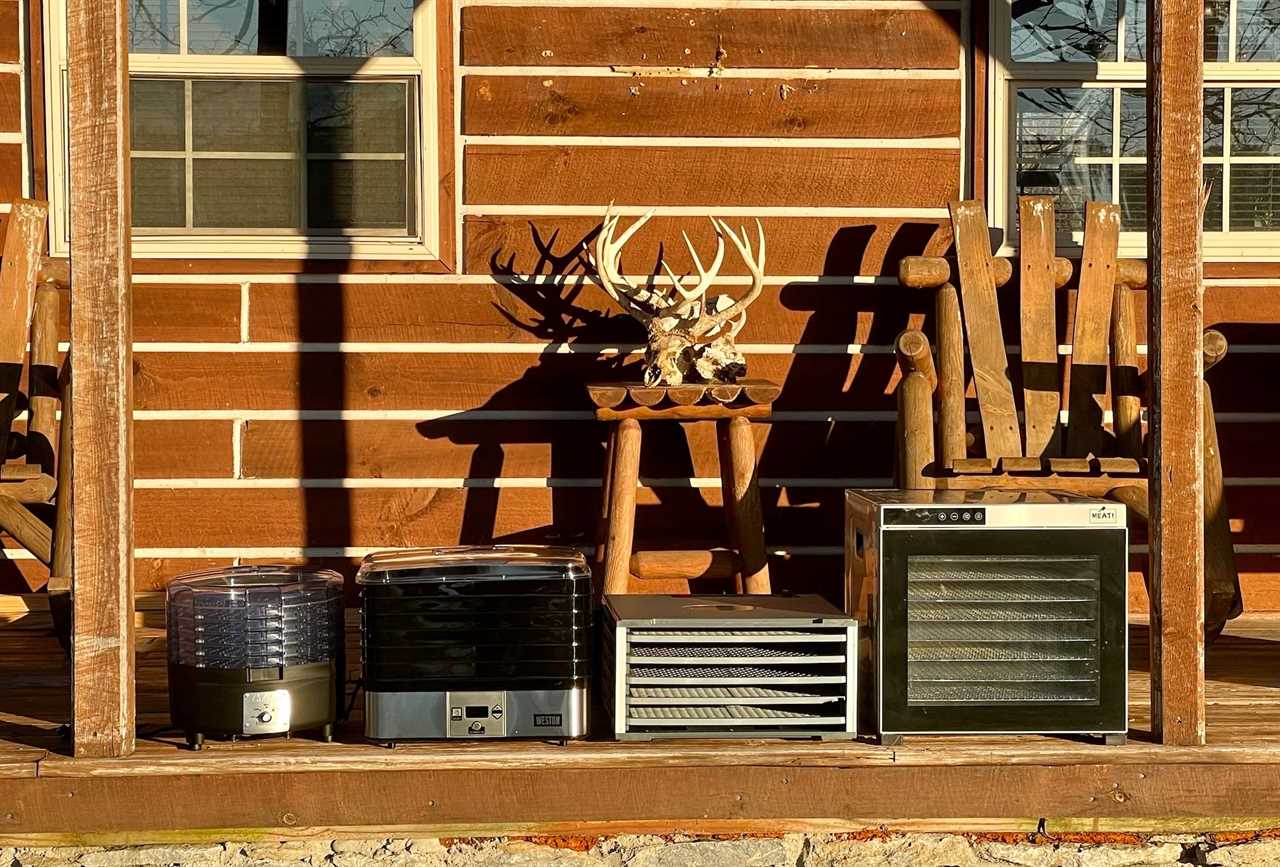 Four of the best dehydrators for jerky in a row on a porch