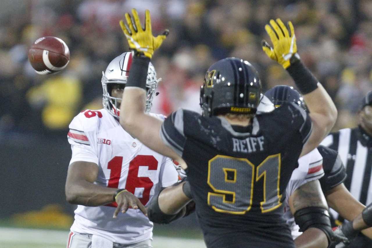 IOWA CITY, IOWA- NOVEMBER 04: Quarterback J.T. Barrett #16 of the Ohio State Buckeyes throws a pass in the fourth quarter past defensive lineman Brady Reiff #91 of the Iowa Hawkeyes, on November 04, 2017