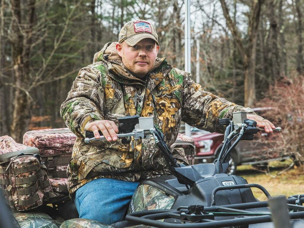 hunter sitting on an atv at deer camp