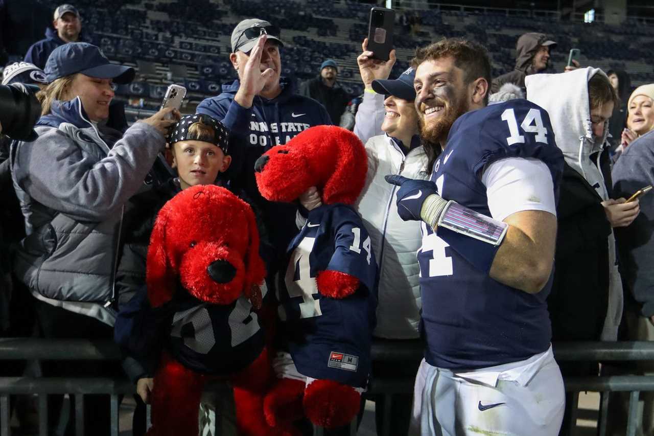 Nov 26, 2022; University Park, Pennsylvania, USA; Penn State Nittany Lions quarterback Sean Clifford (14) poses for a photo with fans following the game against the Michigan State Spartans at Beaver Stadium. Penn State defeated Michigan State 35-16.