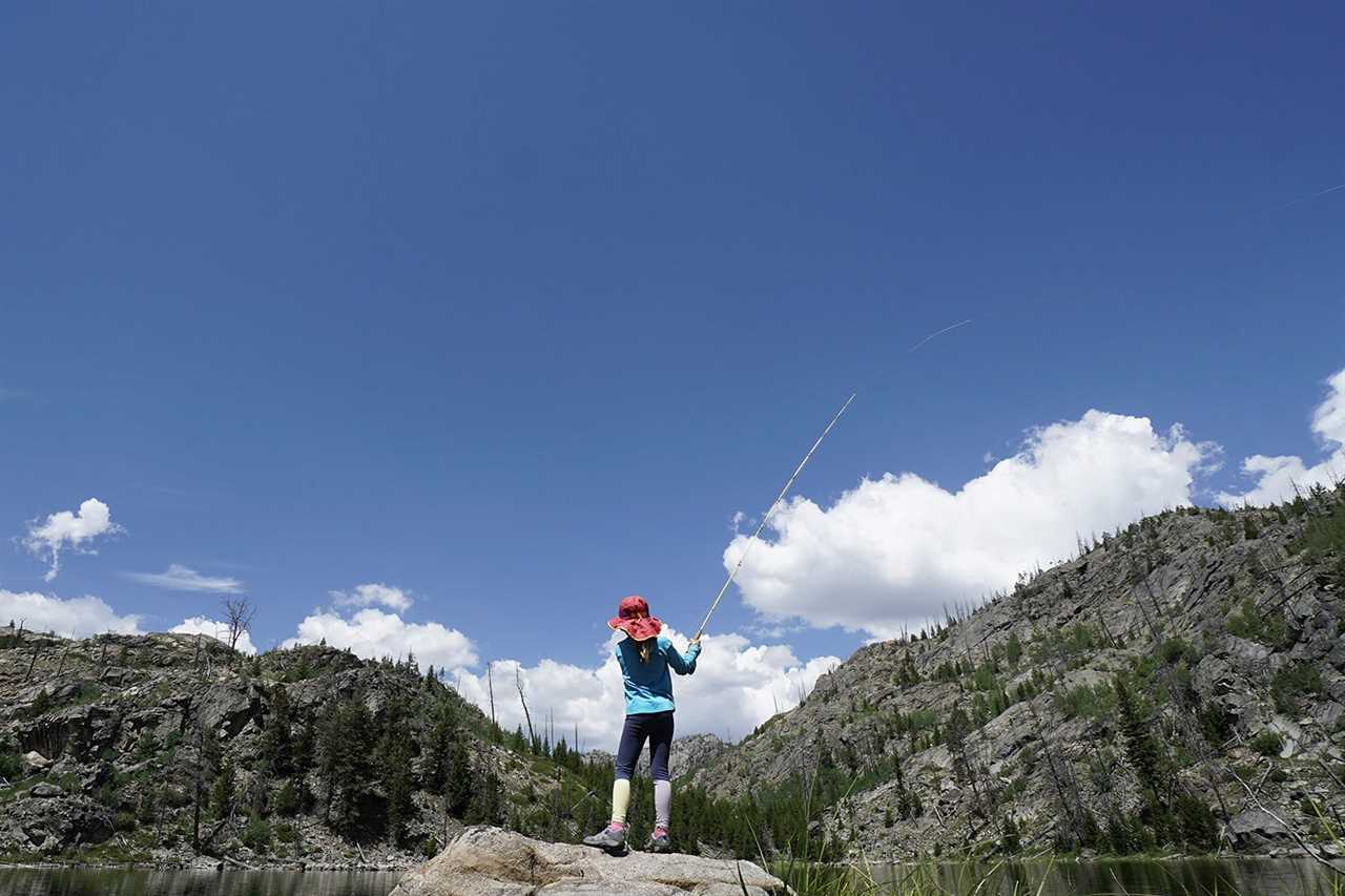 child casts into mountaintop lake