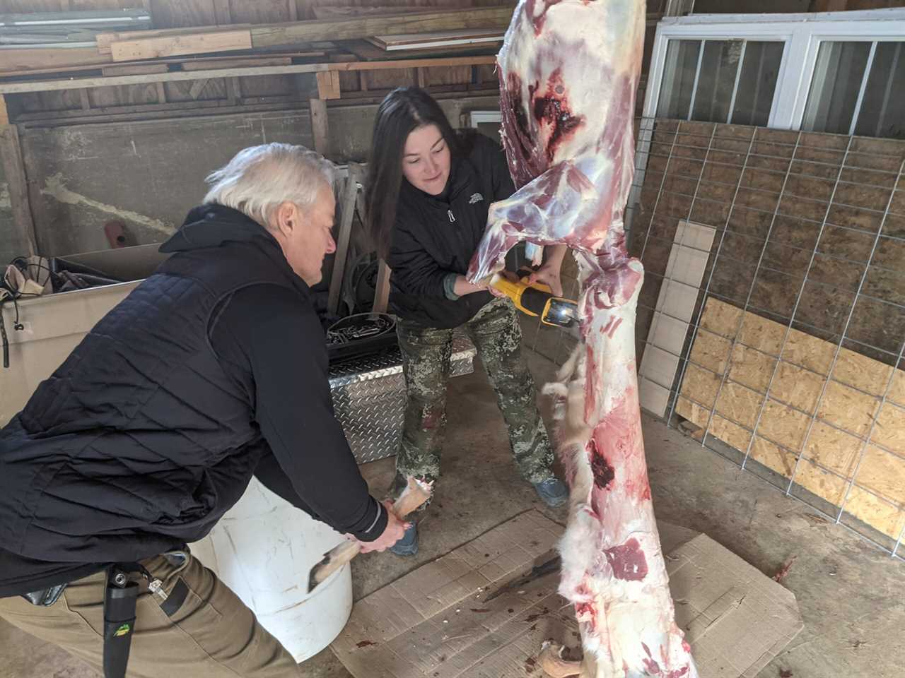 Mr. Krebs helps Thess cut through the legs of her doe.