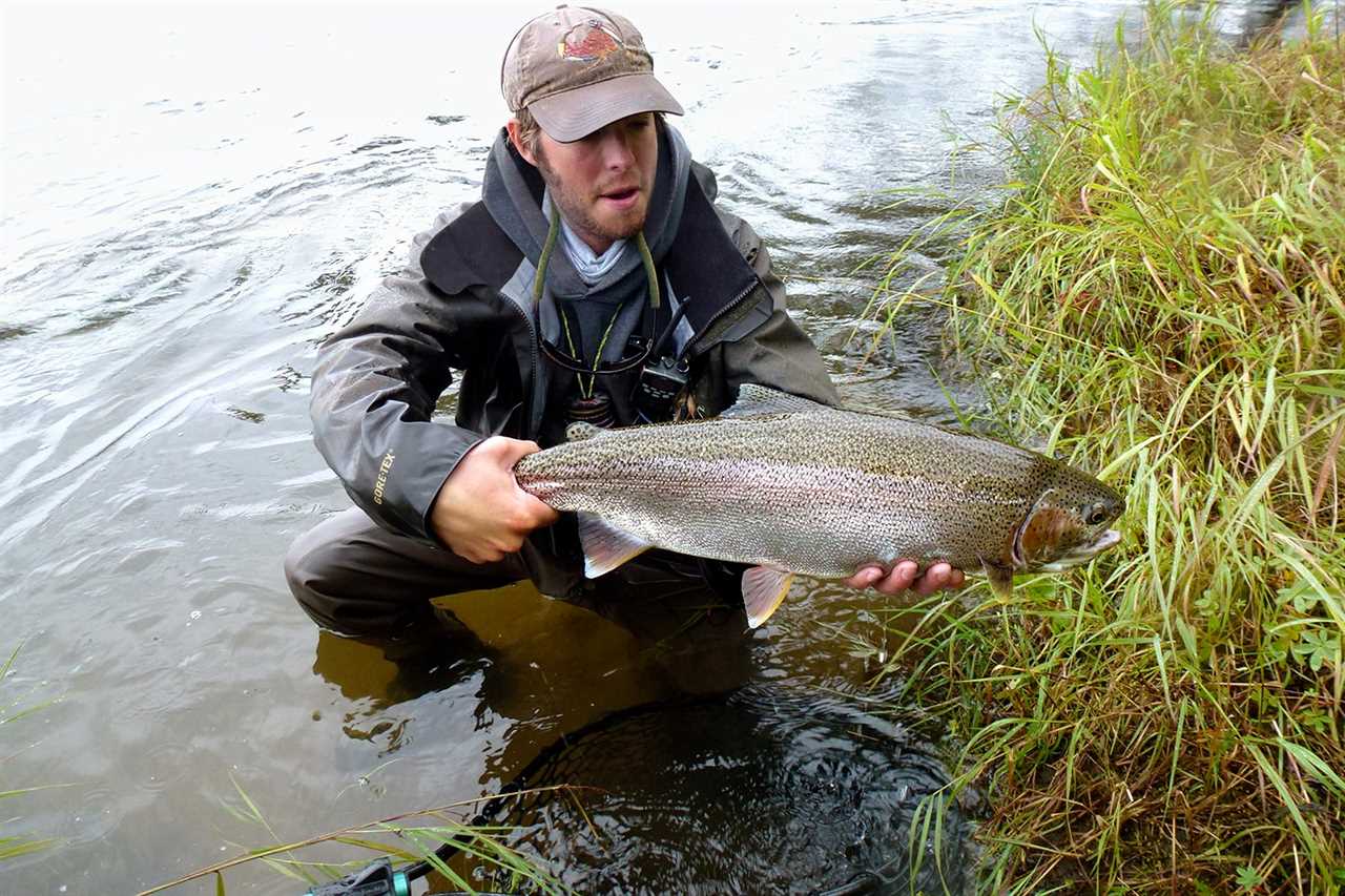 angler holds large trout