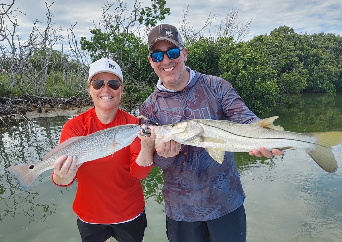 Two anglers sporting the best fishing shirts.