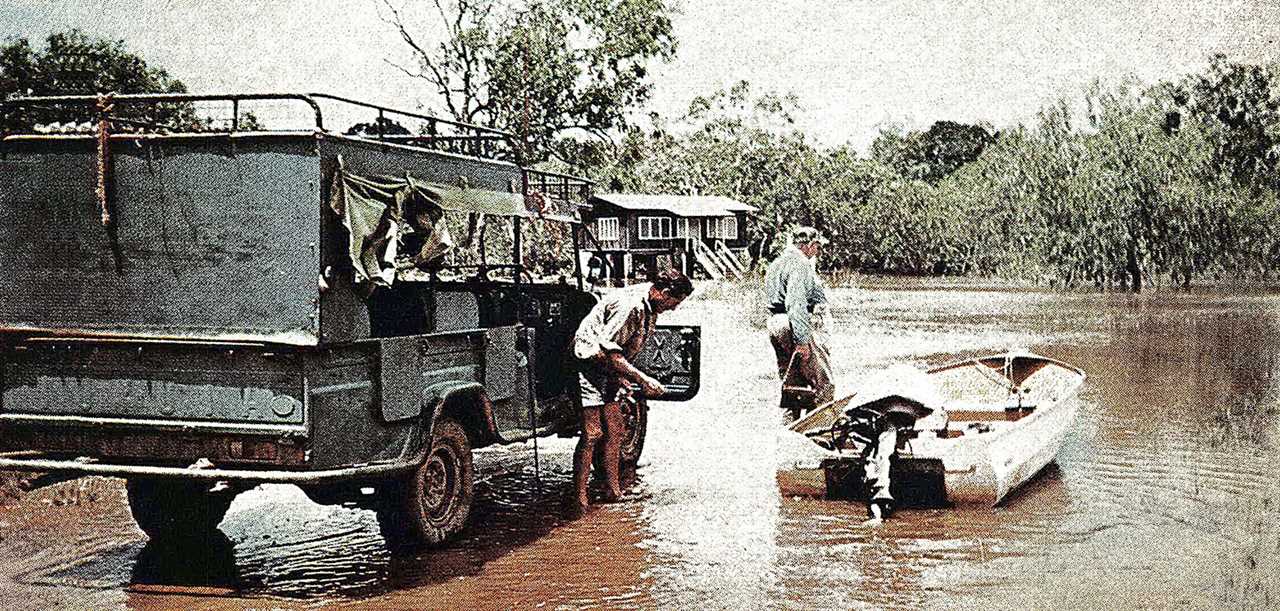 australia flooded area, hunters move into small boat from truck