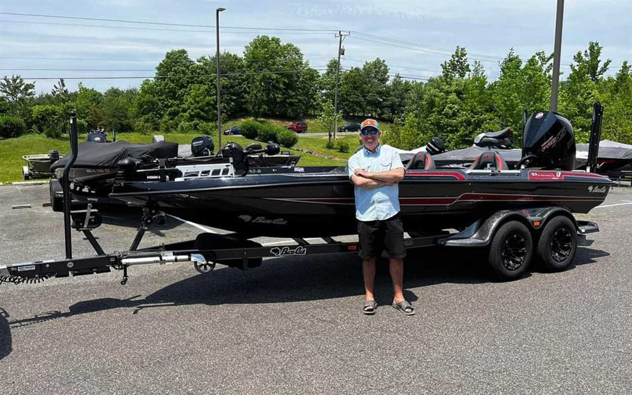 The author stands in front of his new boat.