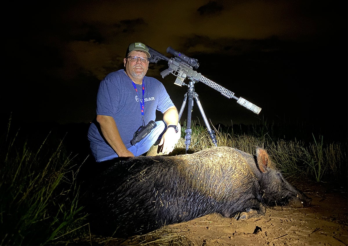 Hunter poses next to hog.