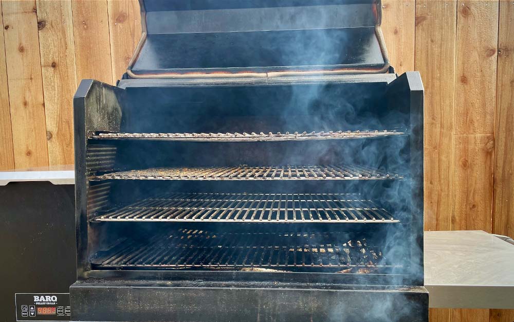 A black pellet smoker smoking