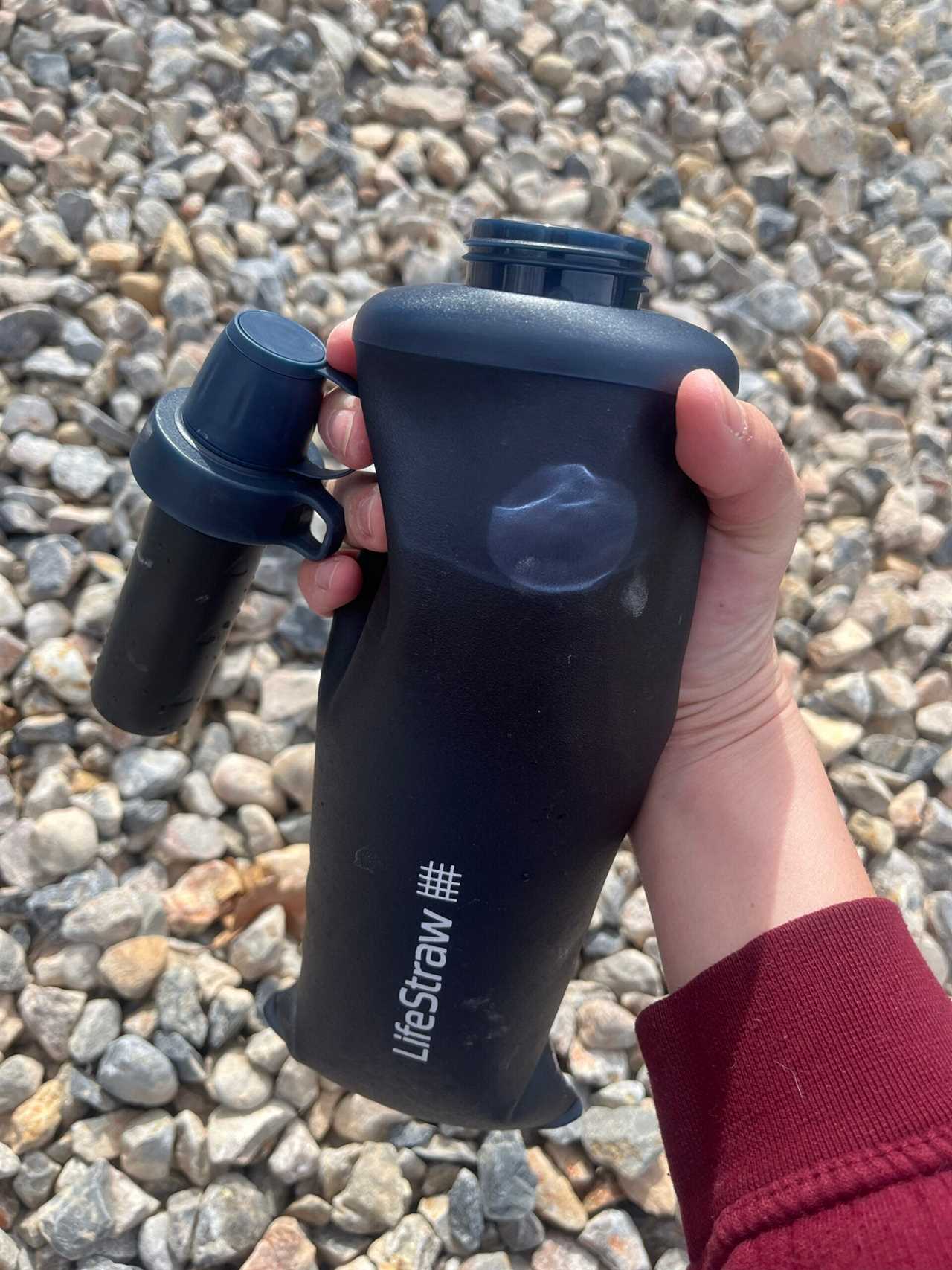 The LifeStraw Peak collapsible water bottle cap has a loop to keep the filter off the ground while filling.