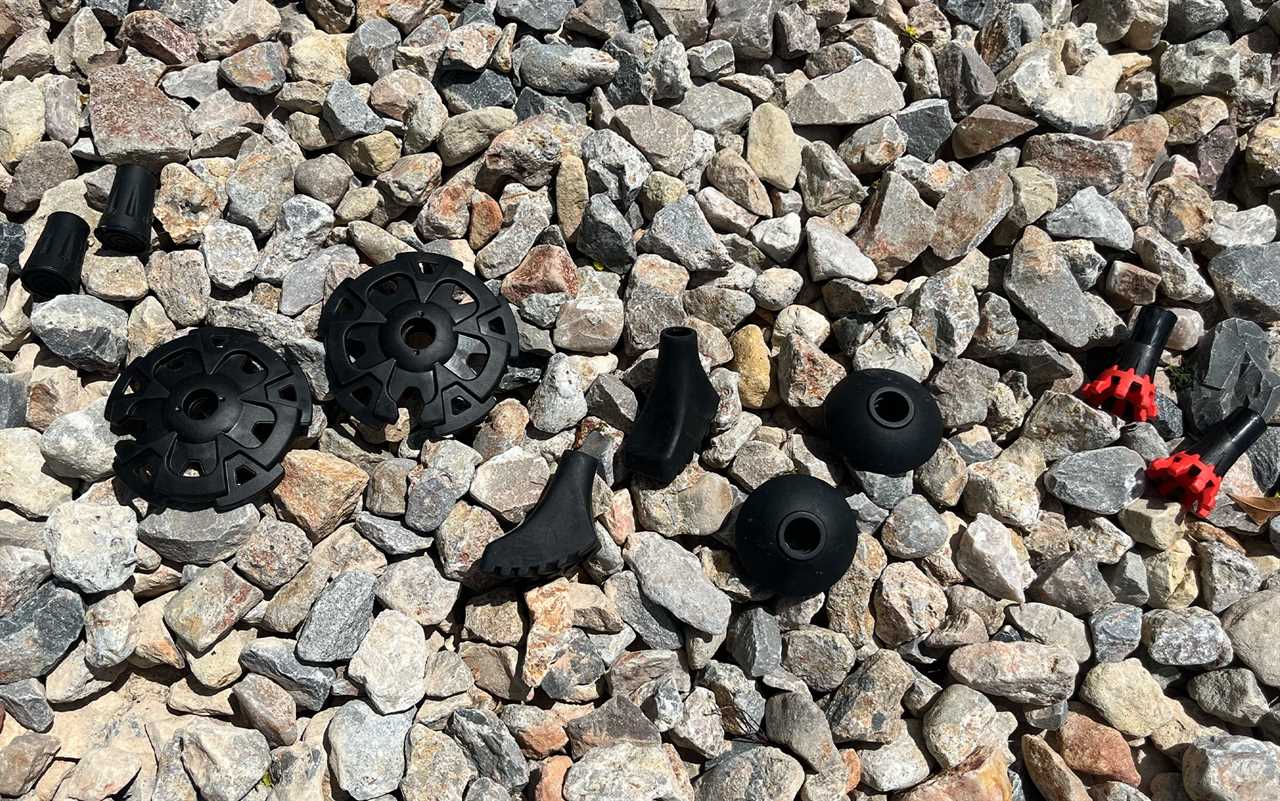 Cascade Mountain Techâs rubber tips, snow baskets, rubber boots, and trekking baskets sit next to TSLâs crossover tip (from left to right).