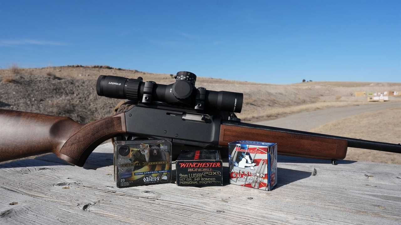 henry homesteader on a table with various 9mm ammo