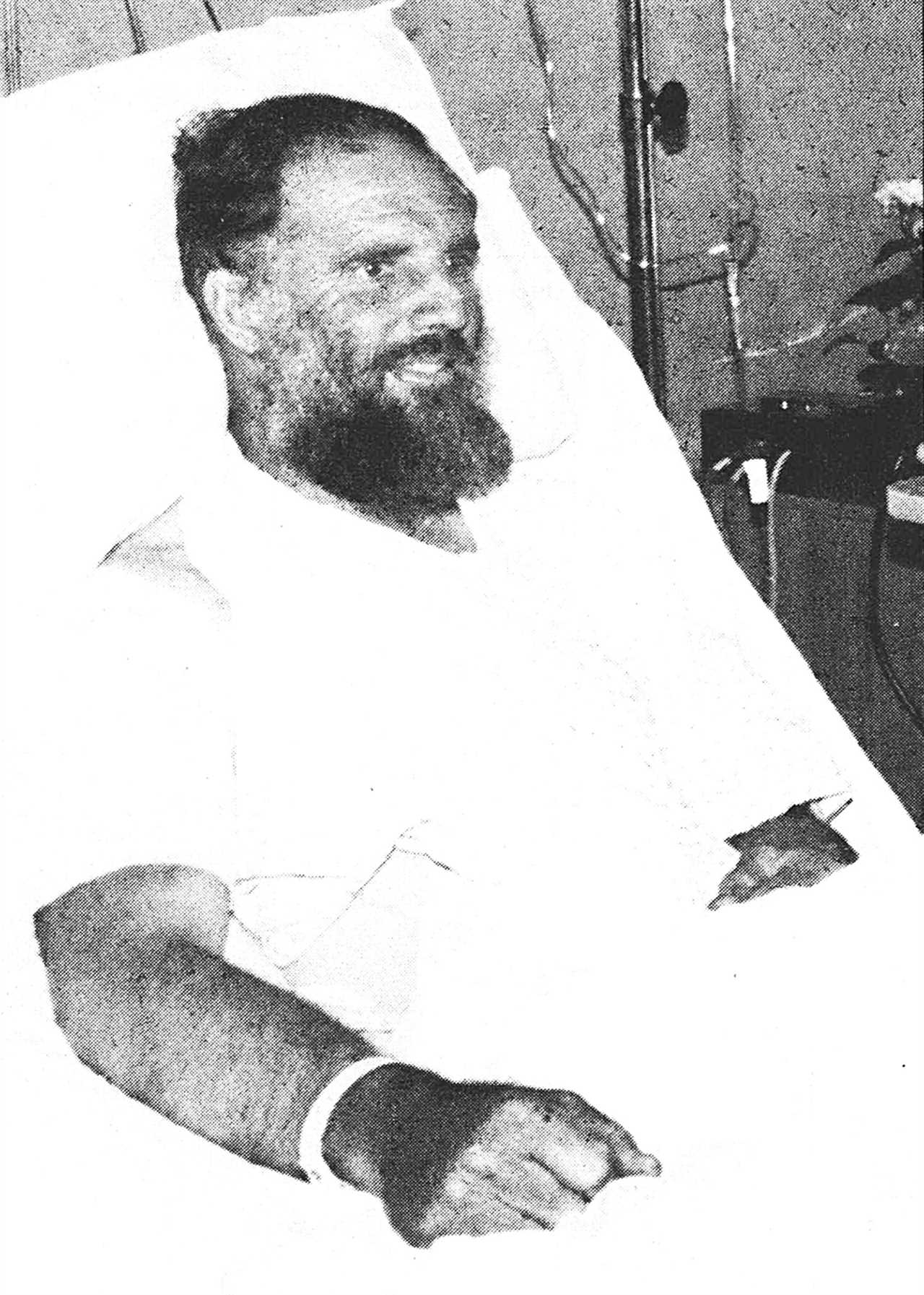 black-and-white image of man in hospital bed
