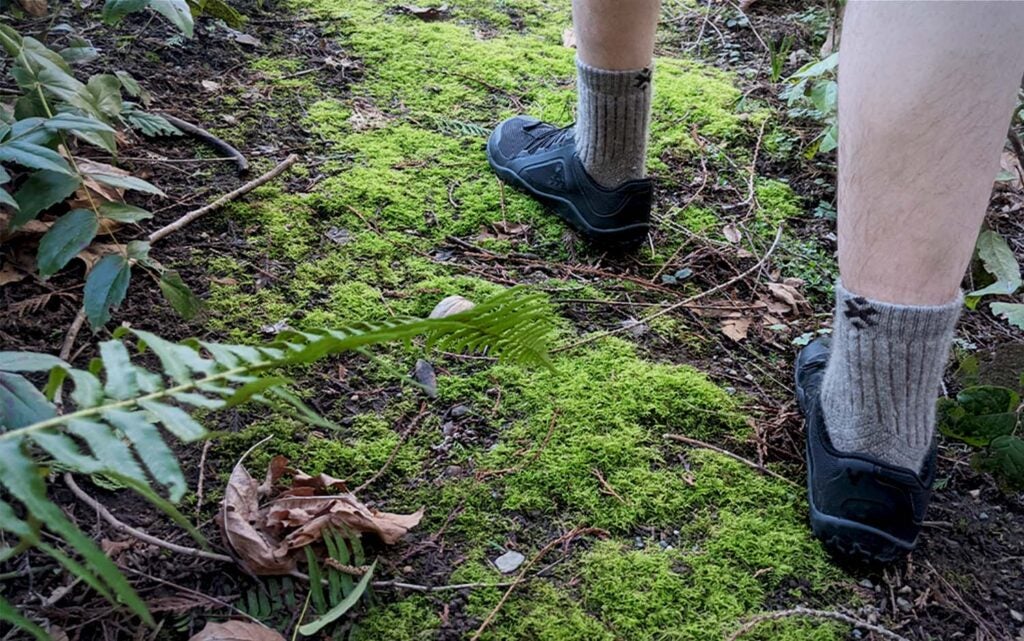 A man's legs with a close up of grey hiking socks