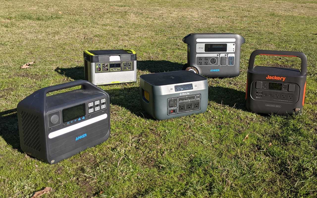 Solar generators sitting in the grass.