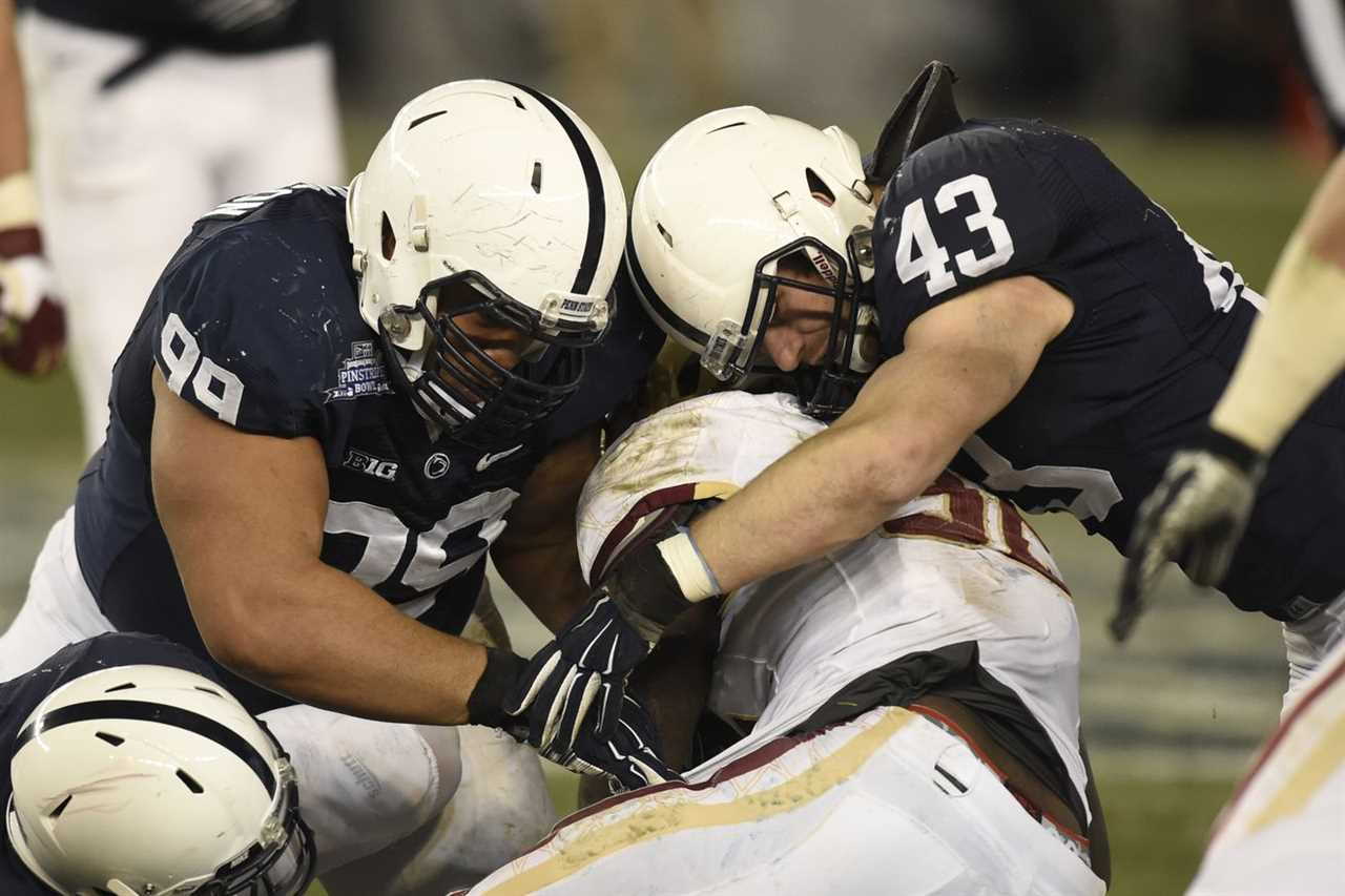 Penn State defensive tackle Austin Johnson (99) and Penn State linebacker Mike Hull (43) tackle Boston College’s Jon Hilliman (32).COLLEGE FOOTBALL Penn State Nittany Lions vs Boston College Eagles in the New Era Pinstripe Bowl at Yankee Stadium, New