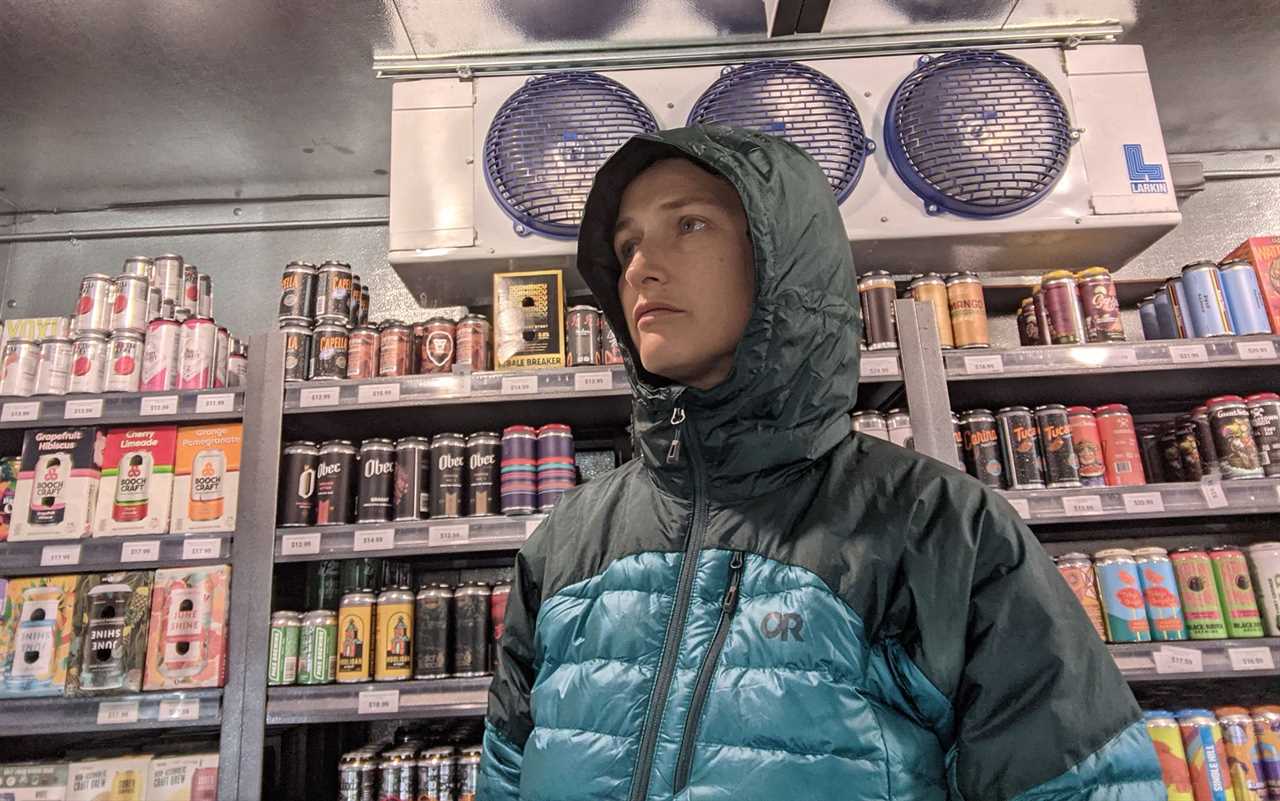 Testing the lofting potential of the Outdoor Research Helium Down Jacket in front of the refrigeration hardware of a local barâs walk-in beer closet.