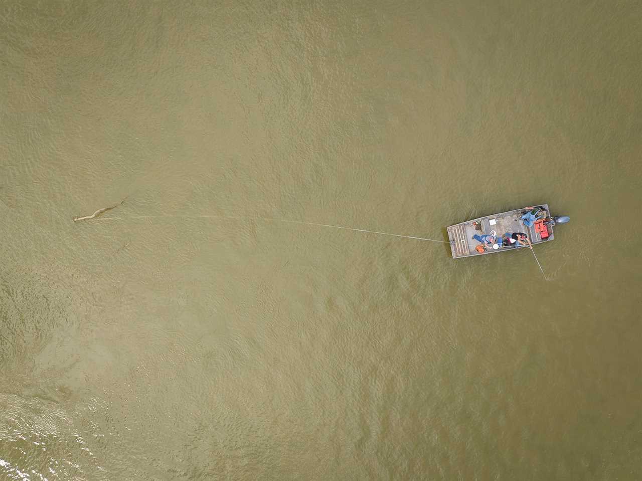 Overhead view of trotliners setting line from a metal boat.