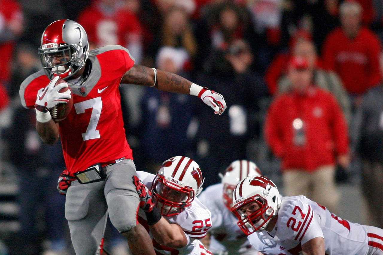 Ohio State Buckeyes running back Jordan Hall (7) gets past Wisconsin Badgers safety Adam Hampton (25) and Wisconsin Badgers running back Kyle Zuleger (27) on a late 4th quarter kickoff return in their NCAA football game at Ohio Stadium in Columbus, Ohio, October 29, 2011.