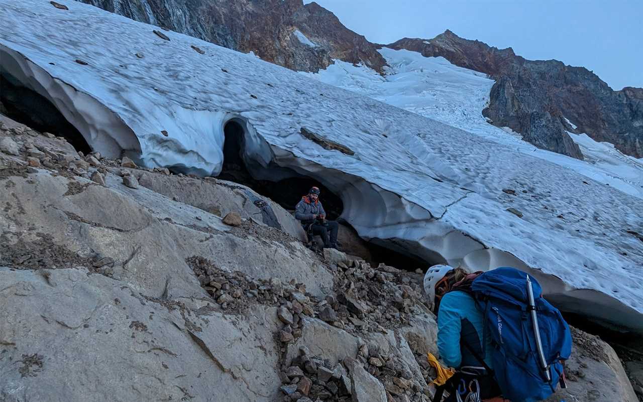 Guide Sitting Next to the Edge of Quien Sabe Glacier