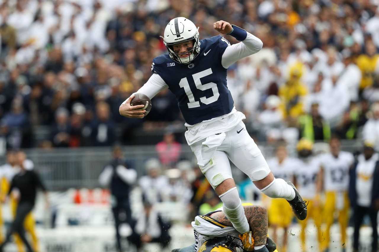 Penn State Nittany Lions quarterback Drew Allar (15) runs the ball against Michigan Wolverines defensive lineman Mason Graham (55) during the second quarter at Beaver Stadium.