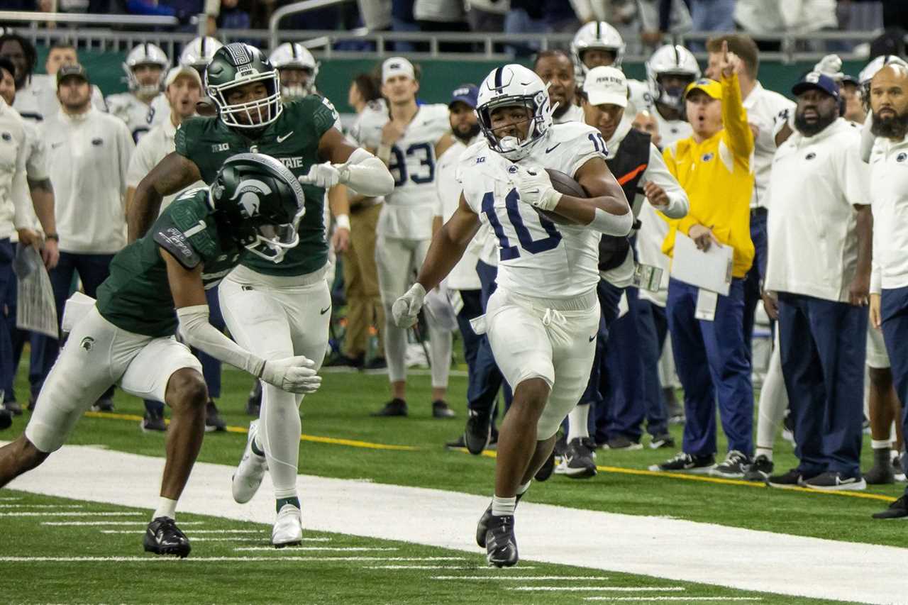 Penn State Nittany Lions running back Nicholas Singleton (10) runs with the ball while chased by Michigan State Spartans defensive back Jaden Mangham (1) during the first half at Ford Field.