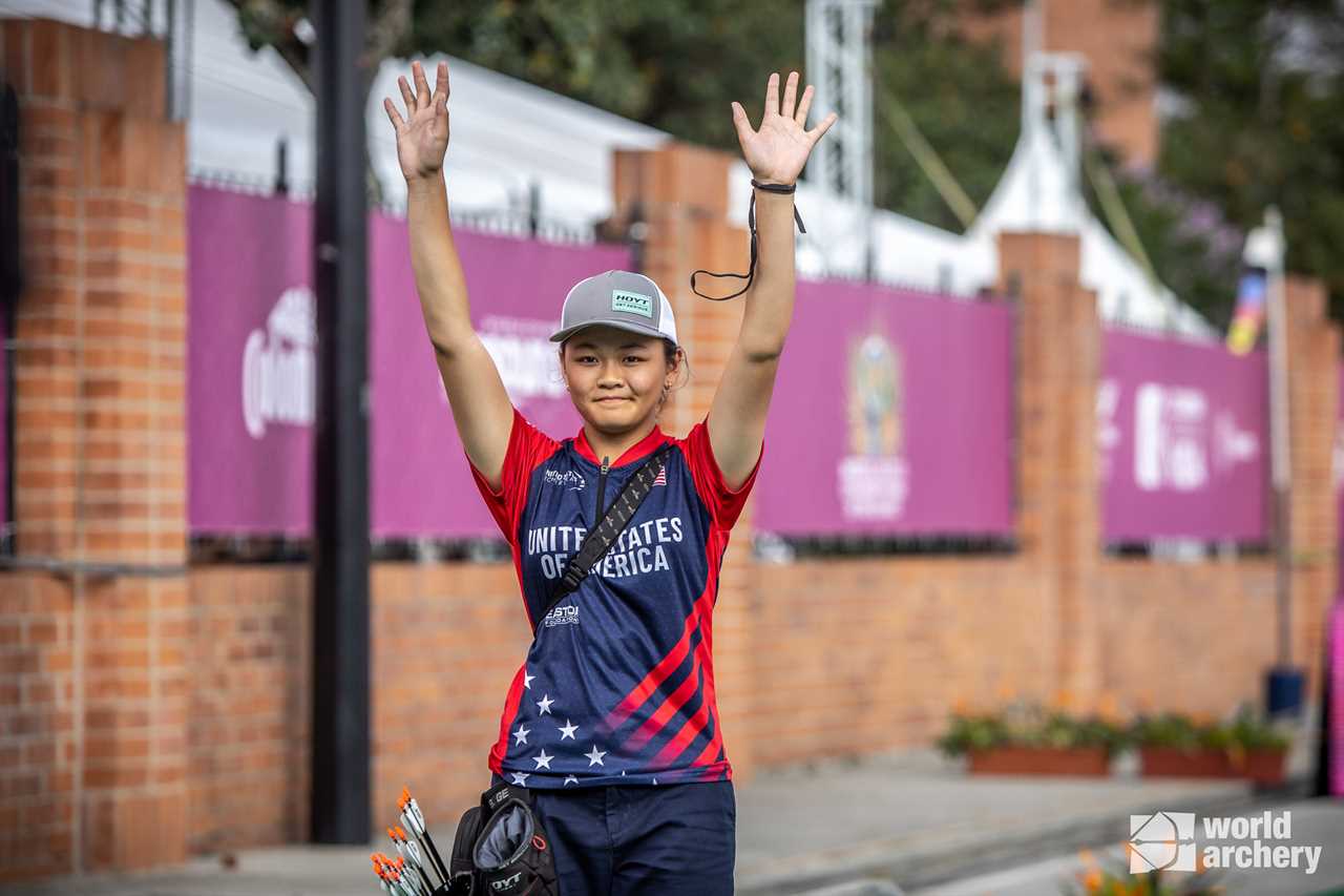 Liko Arreola with her arms raised in triumph.