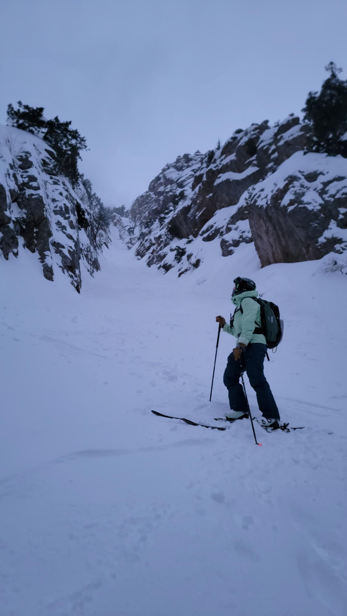 Skier in couloir with Leki poles.