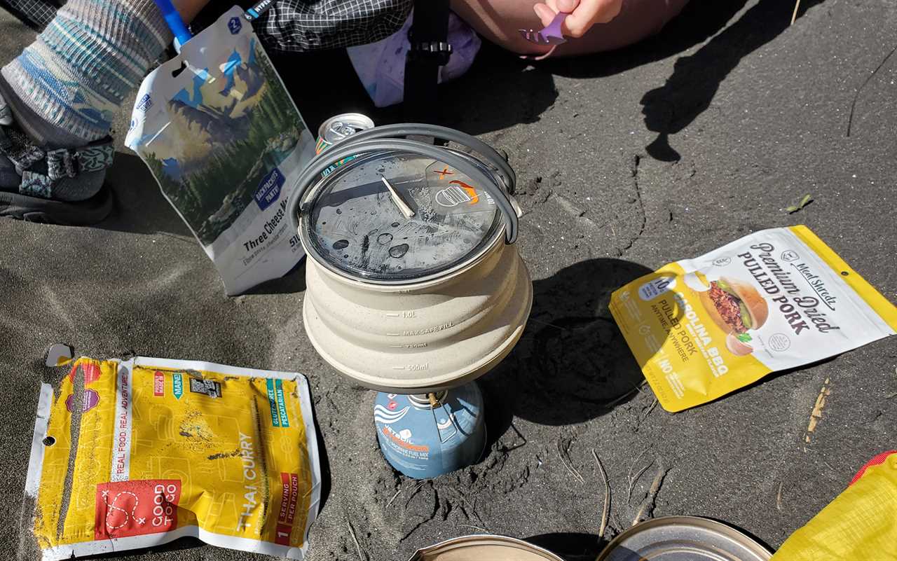 Preparing lunch out of the wind in a sandy ditch.