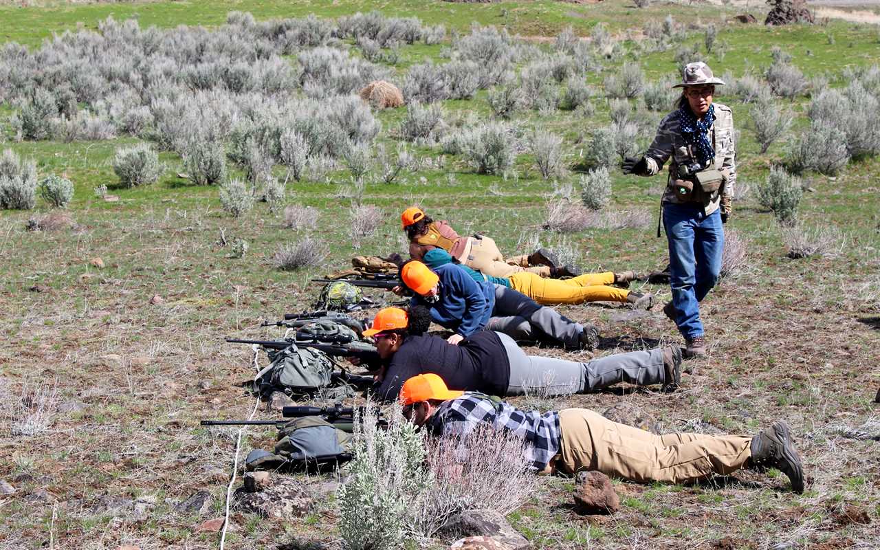 An instructor gives a shooting lesson.